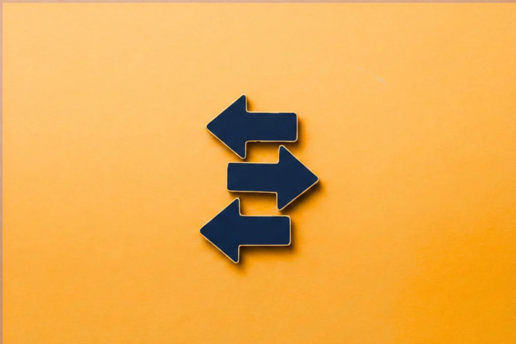 Blue directional arrows on an orange background representing it roadmap planning decisions.